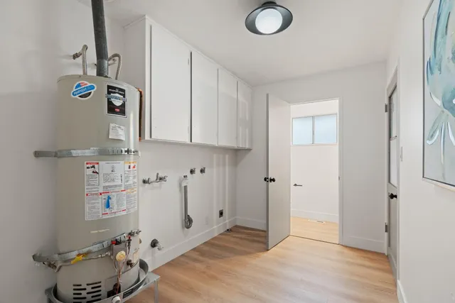 a view of storage and utility room with wooden floor