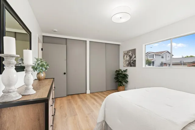 a bedroom with a bed and a potted plant