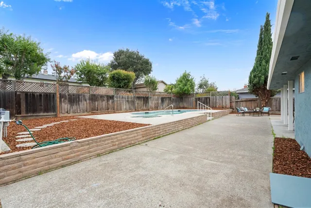 a view of swimming pool with a patio