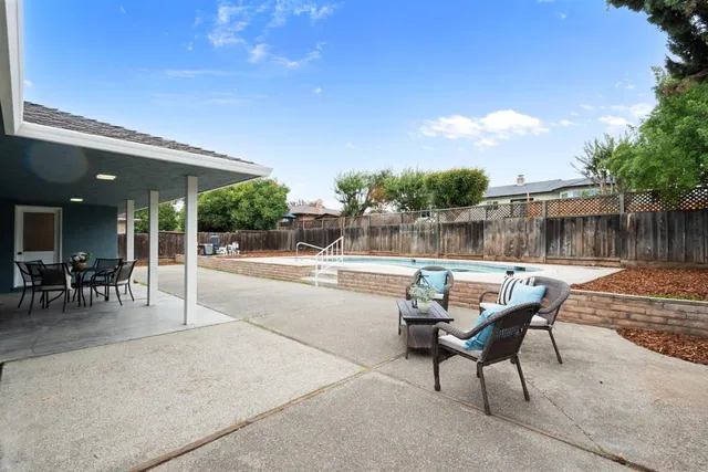 a patio with table and chairs