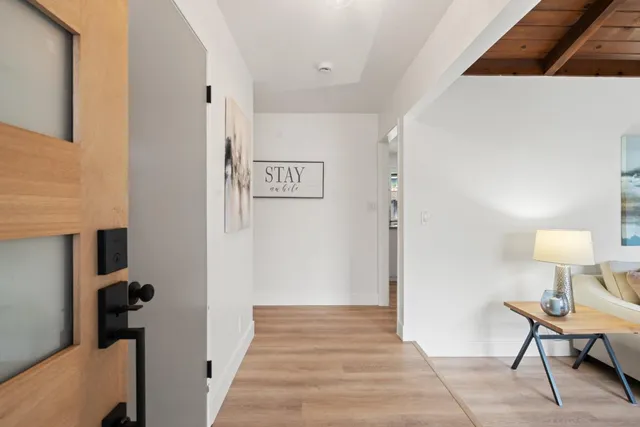 a view of a room that has a bed and a chair in it