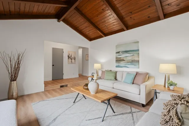 a living room with furniture and a lamp