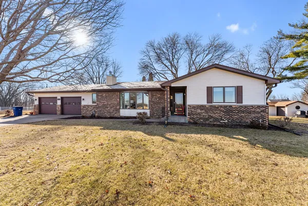 a front view of a house with a yard and porch