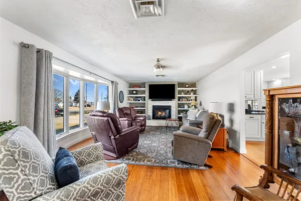 a living room with fireplace furniture and a flat screen tv