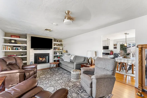 a living room with furniture a fireplace and a flat screen tv