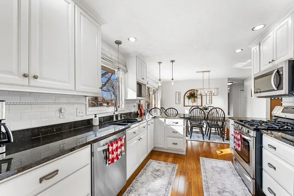 a kitchen with stainless steel appliances granite countertop a stove and a sink