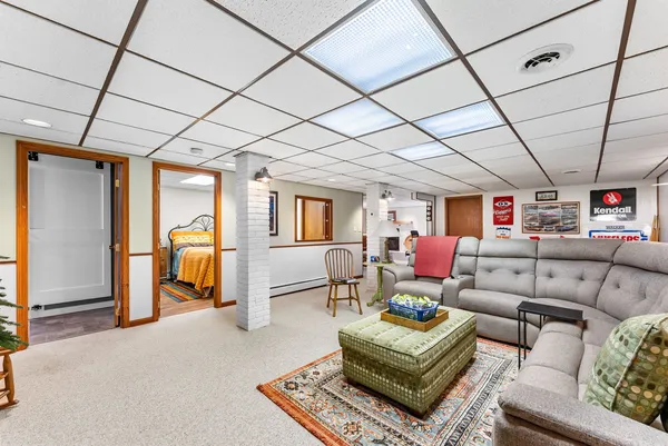 a living room with furniture a rug and a fireplace
