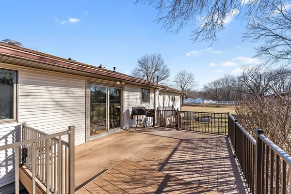 a view of house with backyard and deck