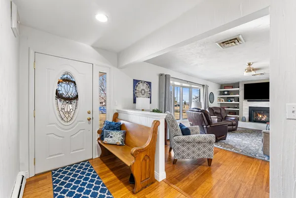 a living room with furniture a couch and a window