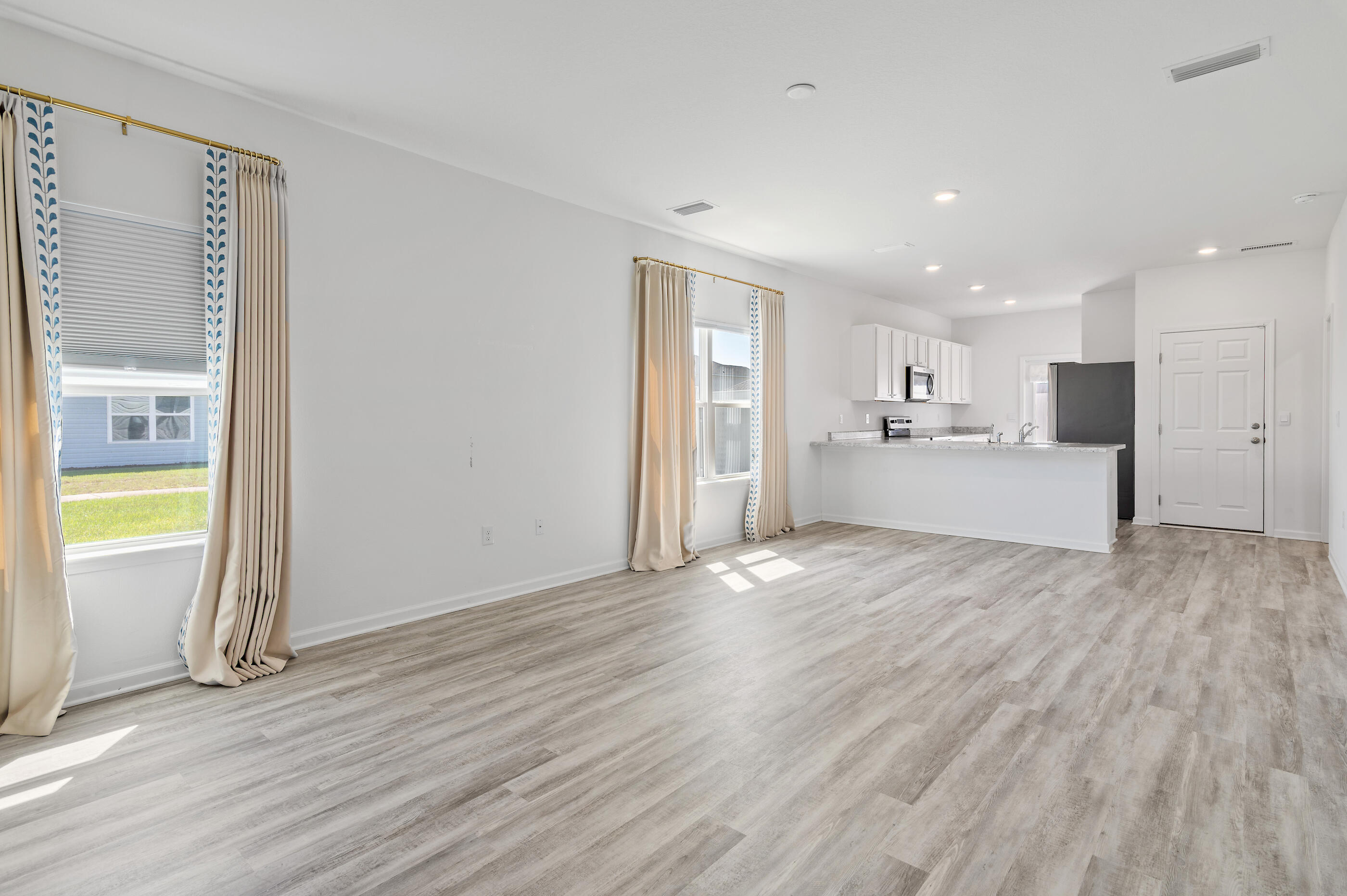 56 Silverthorn Street Freeport, FL 32439 - Photo 4 of 31 a view of a kitchen and a kitchen with wooden floor