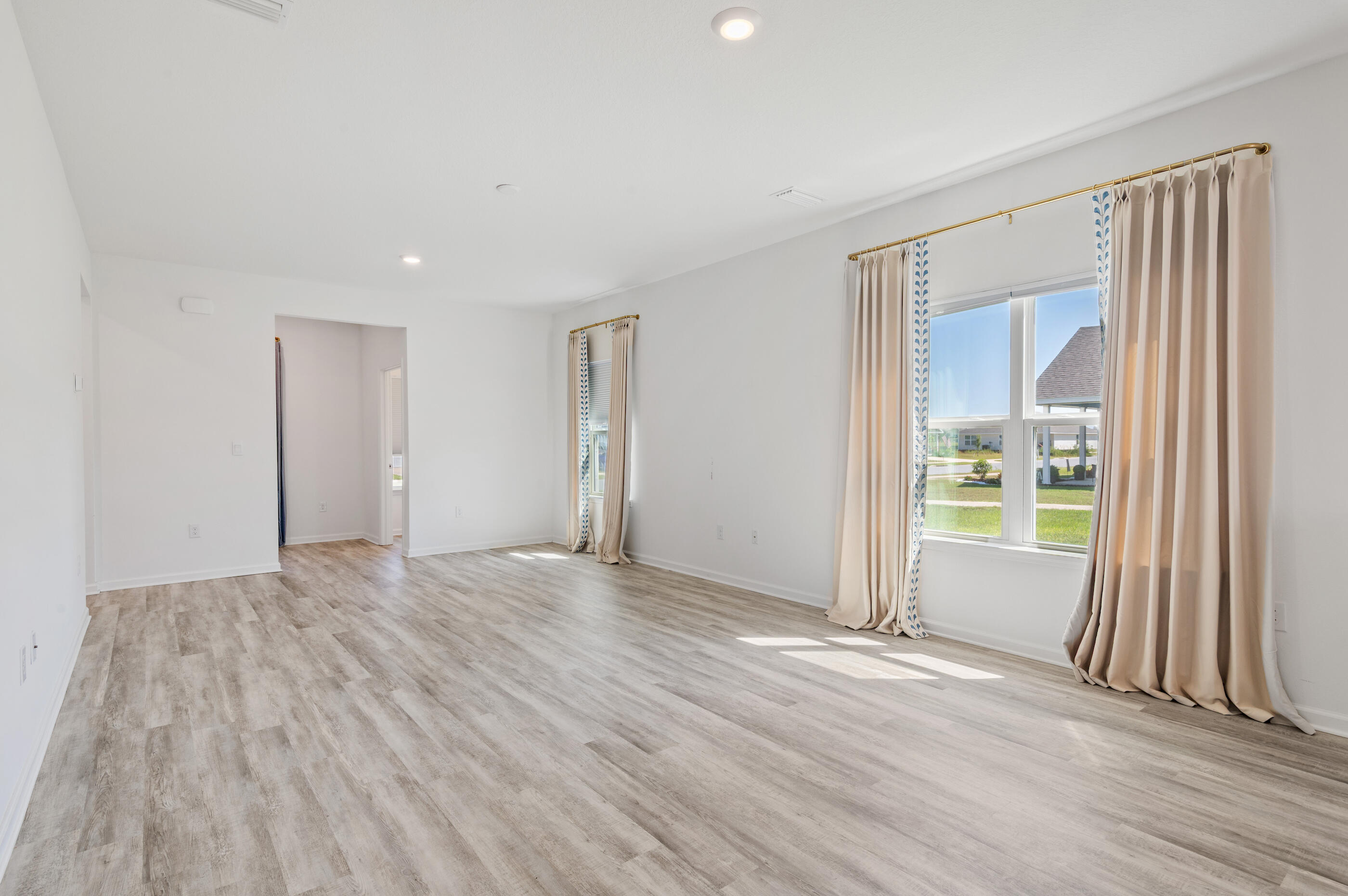 56 Silverthorn Street Freeport, FL 32439 - Photo 6 of 31 a view of an empty room with wooden floor and a window