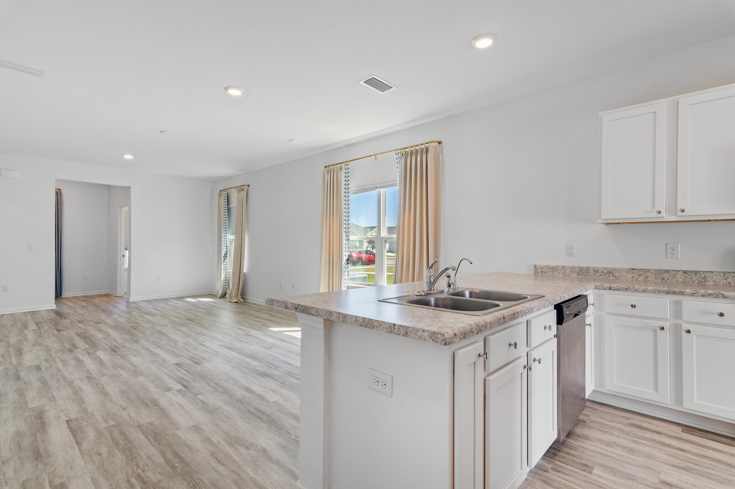 56 Silverthorn Street Freeport, FL 32439 - Photo 7 of 31 a kitchen with a sink stove and cabinets