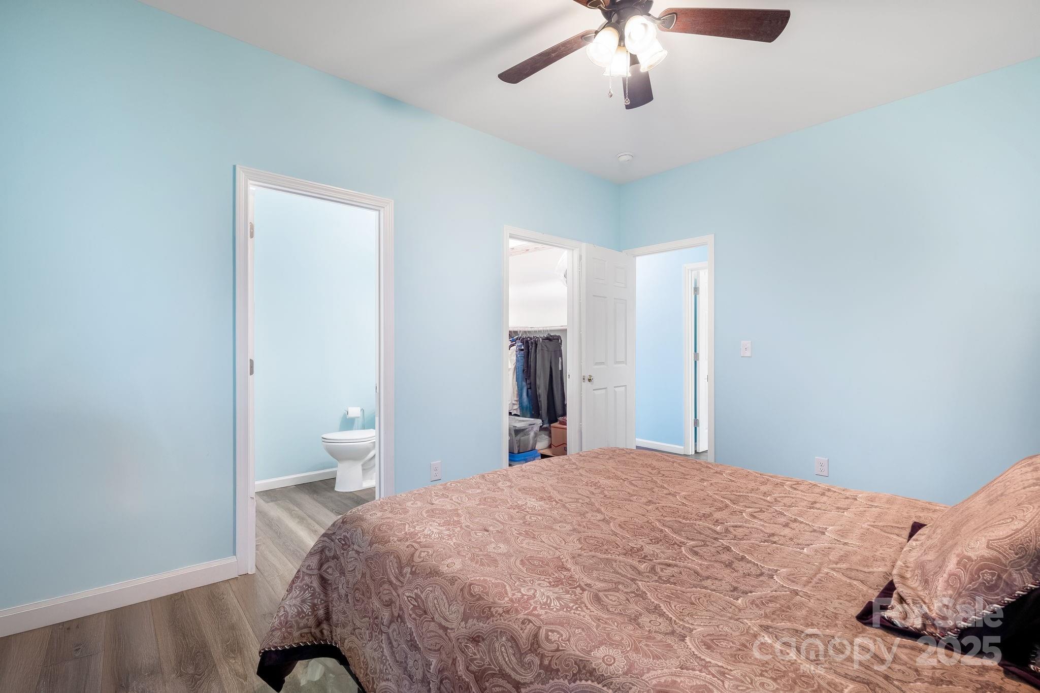 845 Spindale Street Spindale, NC 28160 - Photo 15 of 30 a bedroom with a large bed and a chandelier