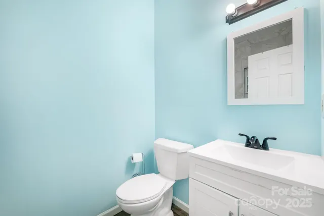 a white toilet sitting next to a bathroom sink