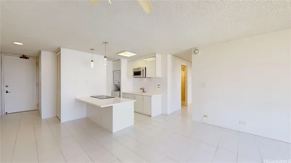 a view of a kitchen with white cabinets and wooden floor