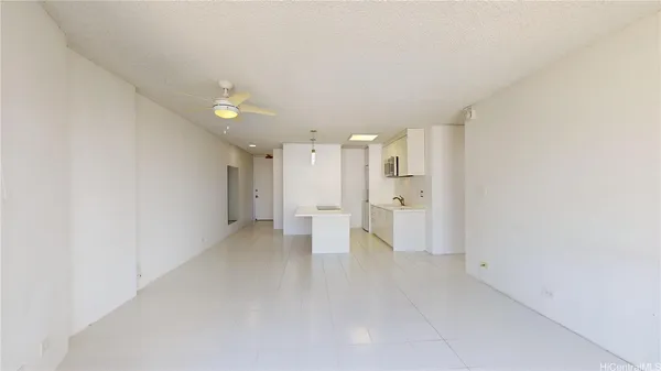 a view of an empty room with a kitchen