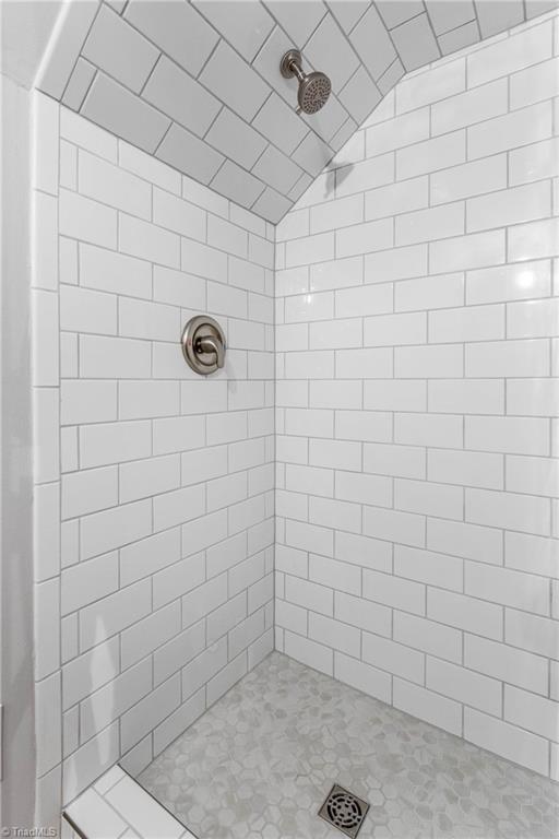 2335 Dobbins Road Boonville, NC 27011 - Photo 30 of 43 Presentable tiled shower in updated bath