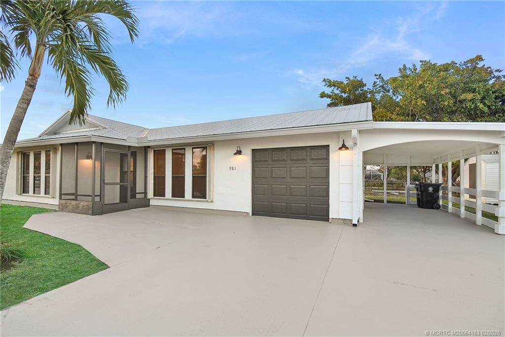 a view of a house with a patio and a yard