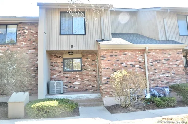 a bathroom with a granite countertop sink a mirror and shower