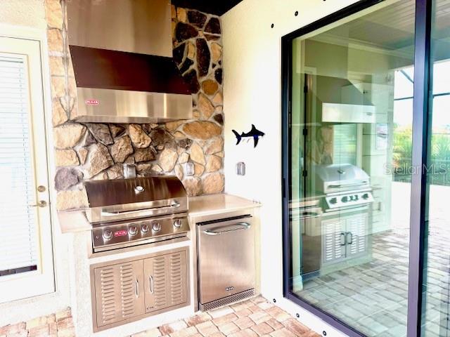 7113 Whittlebury Trail Lakewood Ranch, FL 34202 - Photo 6 of 15 a kitchen with a stove and a refrigerator