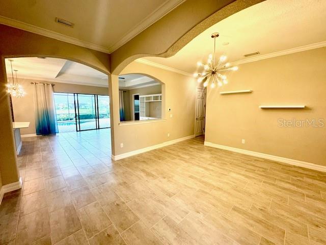 7113 Whittlebury Trail Lakewood Ranch, FL 34202 - Photo 9 of 15 a view of a big room with wooden floor and windows