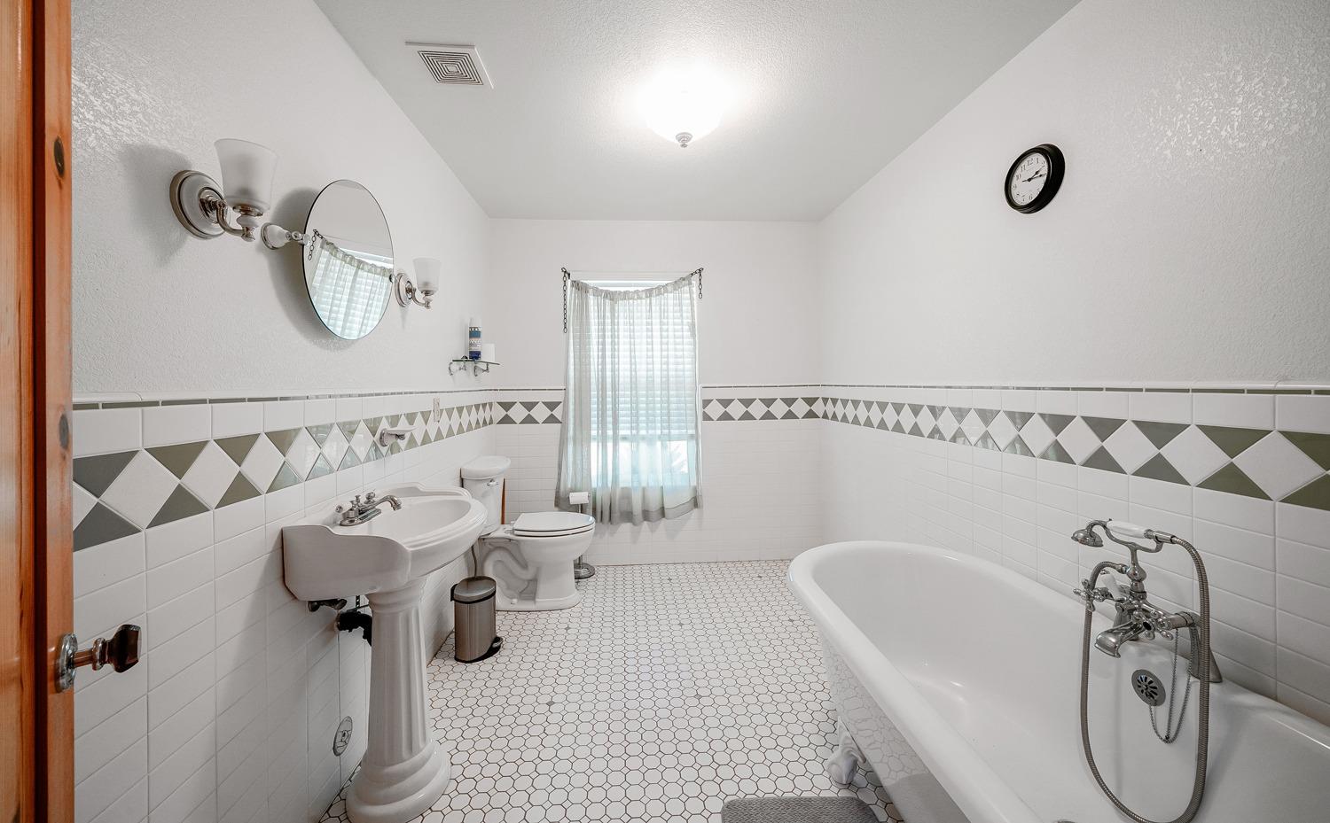 37491 Verde Avenue Madera, CA 93636 - Photo 14 of 66 a bathroom with a tub sink and mirror