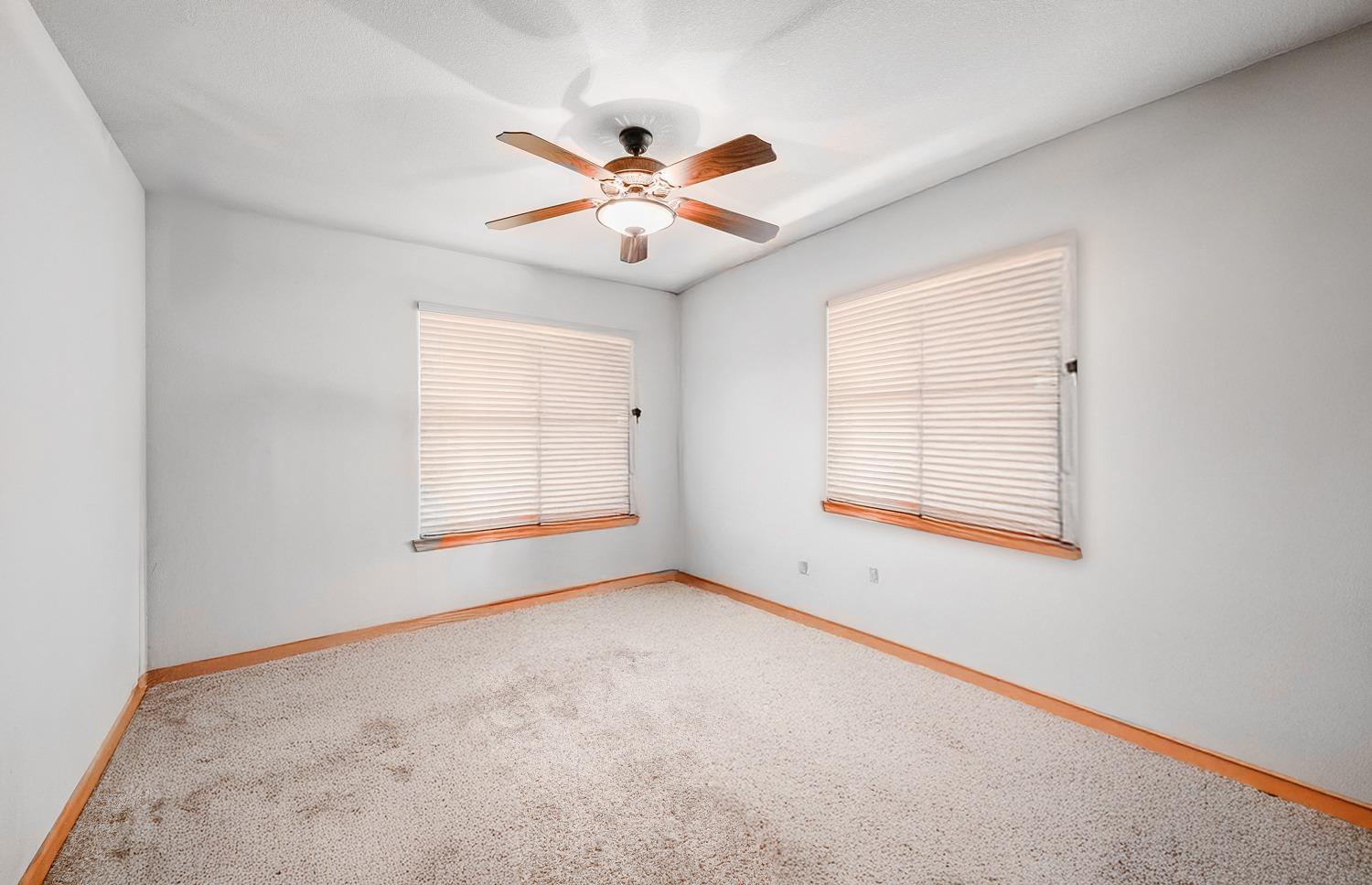 37491 Verde Avenue Madera, CA 93636 - Photo 15 of 66 an empty room with windows and fan