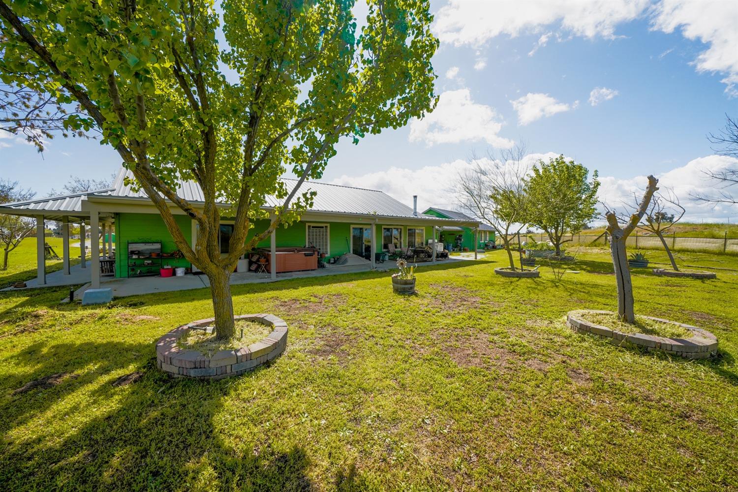 37491 Verde Avenue Madera, CA 93636 - Photo 27 of 66 a view of a swimming pool with a yard