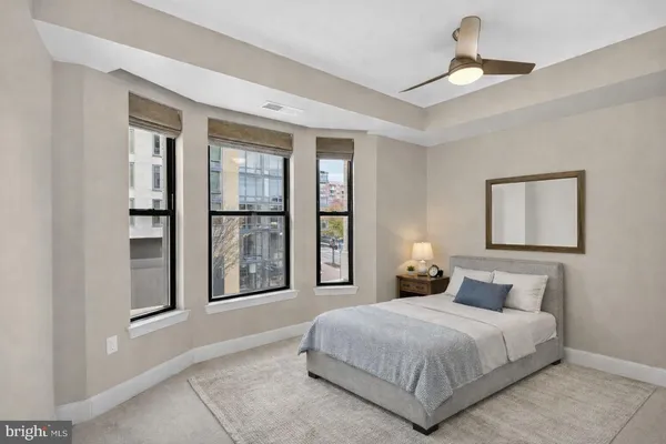 a bedroom with a large bed and a chandelier