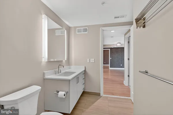 a bathroom with a sink toilet and mirror
