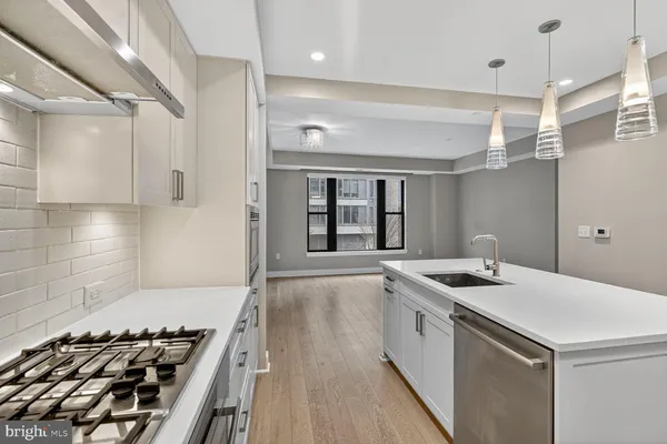 a kitchen that has a stove and a sink