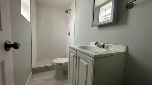 a bathroom with a sink toilet and a mirror