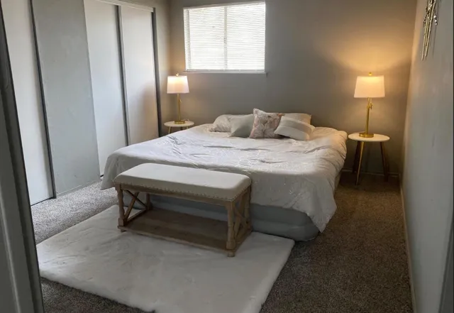 a bedroom with a bed and window