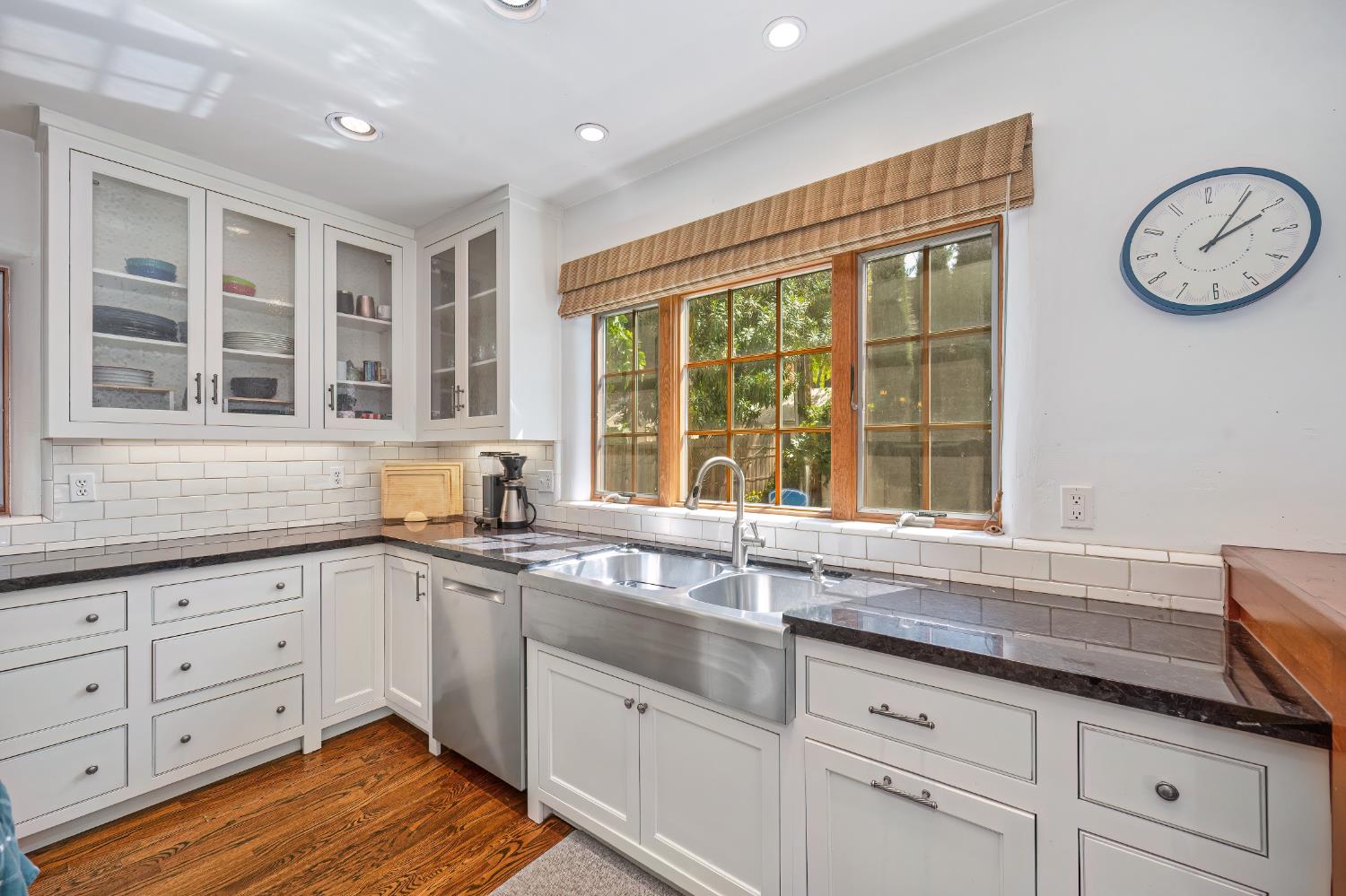 3501 Cutter Way Sacramento, CA 95818 - Photo 16 of 89 a kitchen with granite countertop a sink and white cabinets with wooden floor