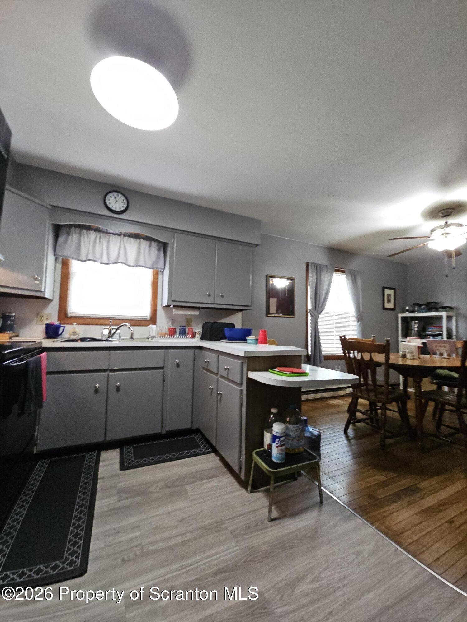 405 Baker Street Taylor, PA 18517 - Photo 9 of 36 a kitchen with counter space dining table and chair