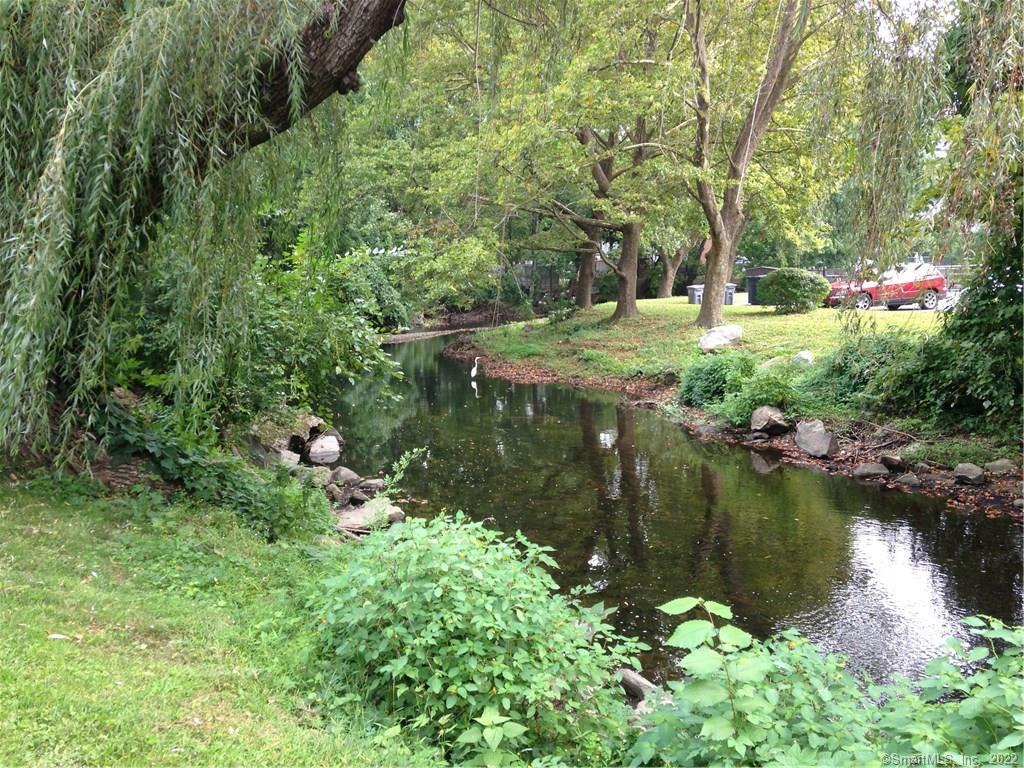 154 Cold Spring Road, Unit 10 Stamford, CT 06905 - Photo 1 of 1 a backyard of a house with a yard and outdoor seating
