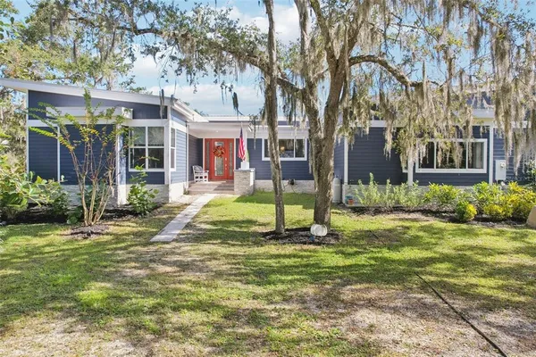 a view of a house with a yard porch and sitting area