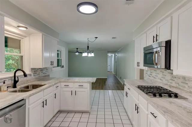 a kitchen with a sink stove and cabinets