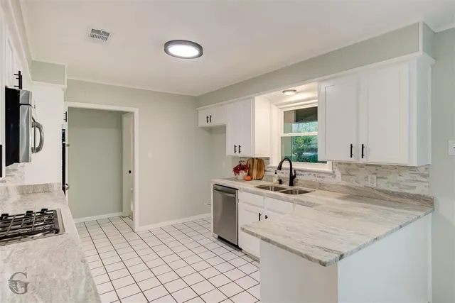 a kitchen with a sink stove and cabinets