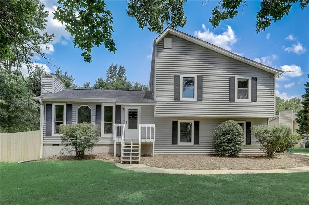 2683 Tucson Way Powder Springs, GA 30127 - Photo 1 of 1 a front view of a house with a garden