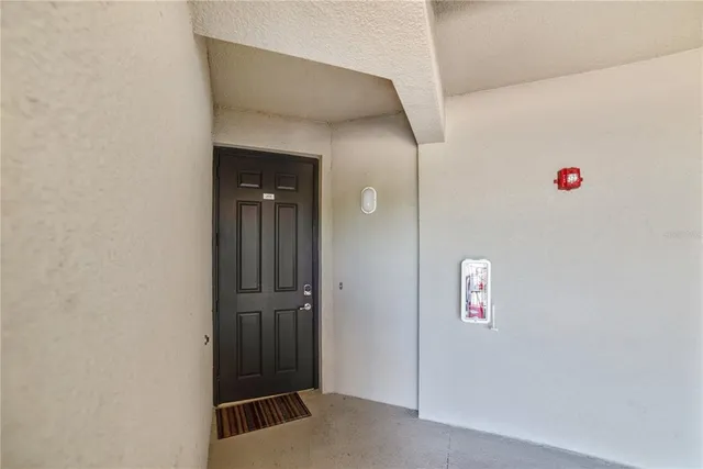 a view of a room with windows and ceiling fan