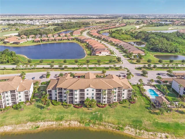 a view of a swimming pool with a bench and trees in the background