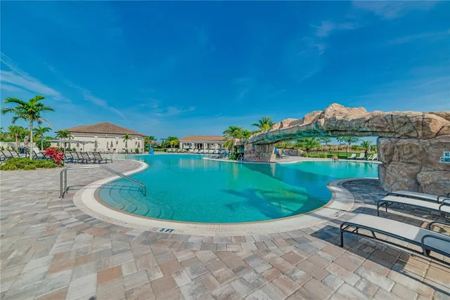 a living room with furniture large window and wooden floor