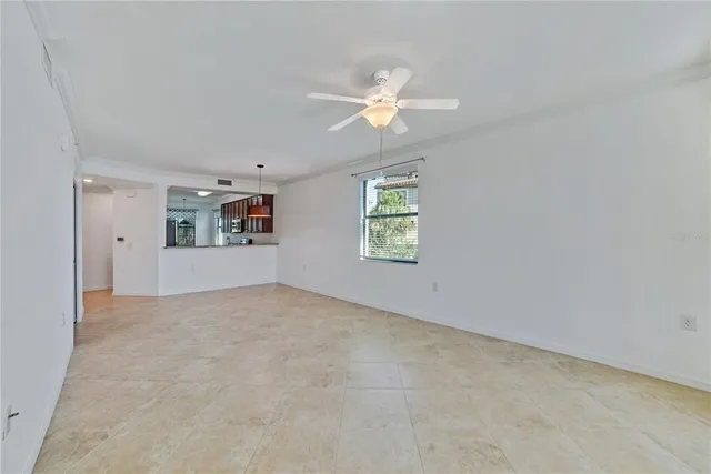 a view of a kitchen with a sink and a chandelier fan