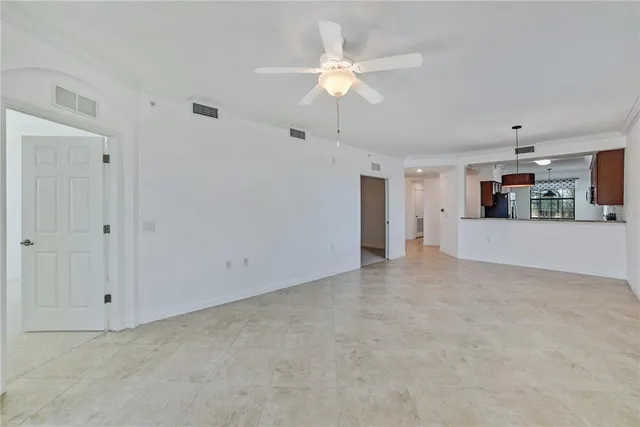 an empty room with windows and chandelier