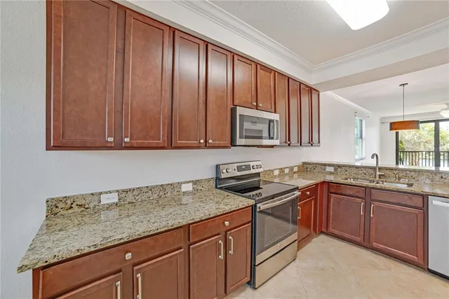 a kitchen with granite countertop cabinets stainless steel appliances and wooden cabinets