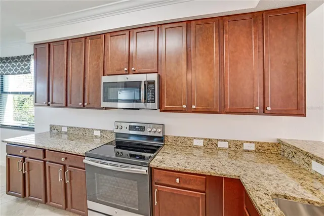 a kitchen with granite countertop a sink and cabinets