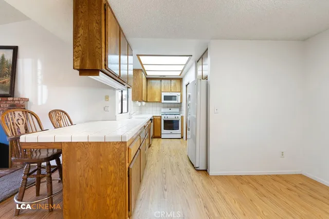 a kitchen with stainless steel appliances granite countertop a sink and cabinets