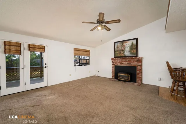 a view of an empty room with a fireplace