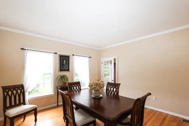 a view of a dining room with furniture and window